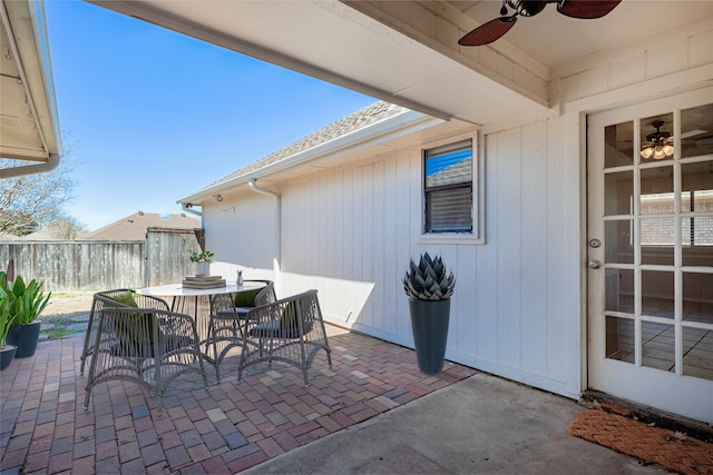 view of patio / terrace featuring outdoor dining space, fence, and ceiling fan