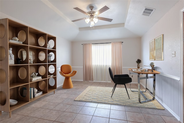 home office featuring tile patterned flooring, visible vents, ceiling fan, and a raised ceiling