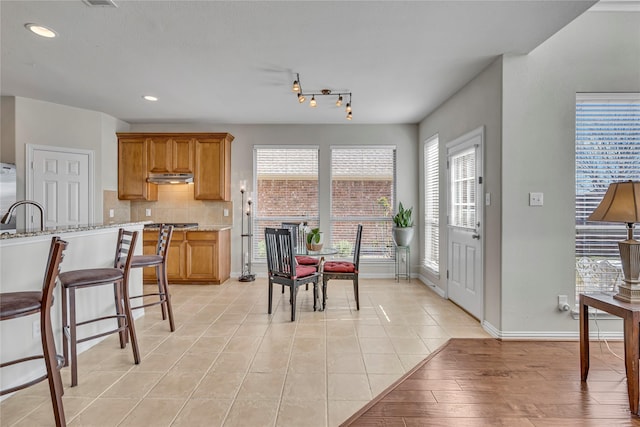 dining room featuring light tile patterned floors, recessed lighting, and baseboards