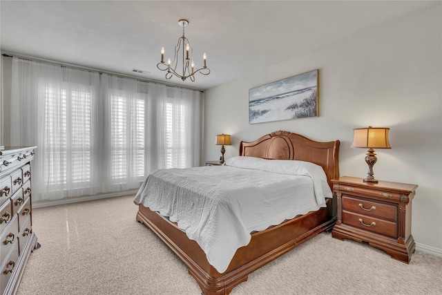 bedroom featuring a notable chandelier, visible vents, and light colored carpet