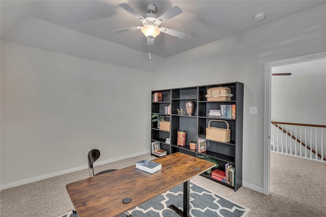 carpeted office with lofted ceiling, ceiling fan, and baseboards