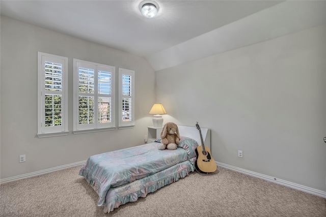 bedroom with vaulted ceiling, carpet, and baseboards