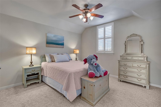 bedroom with lofted ceiling, light carpet, baseboards, and a ceiling fan