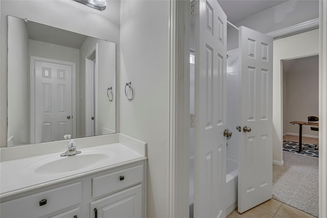 bathroom with tile patterned floors, bathing tub / shower combination, baseboards, and vanity