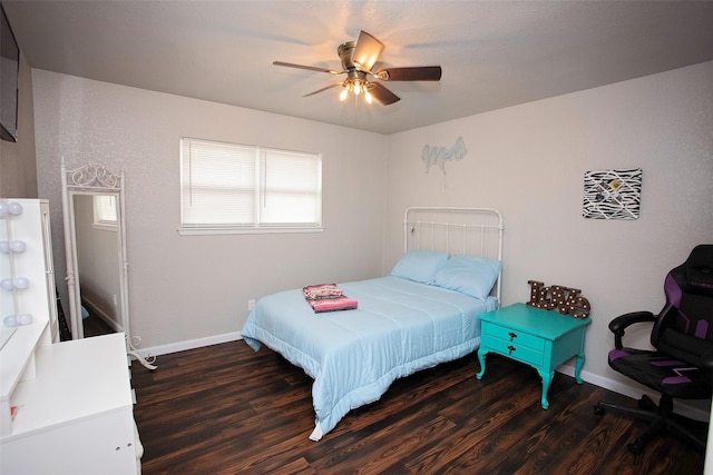 bedroom with a ceiling fan, baseboards, and wood finished floors