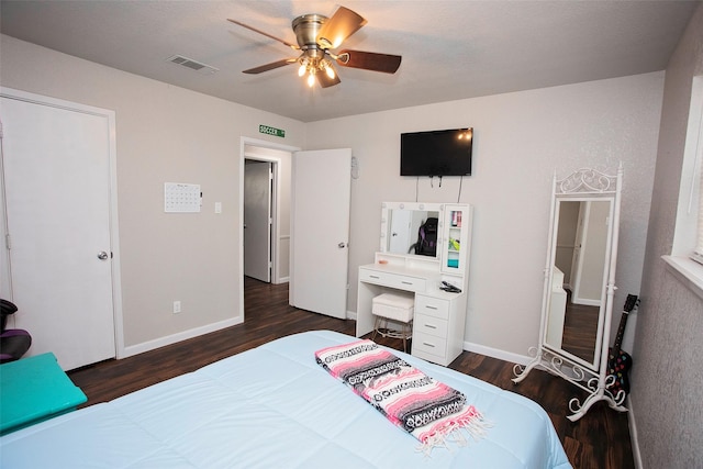 bedroom with visible vents, ceiling fan, baseboards, and wood finished floors