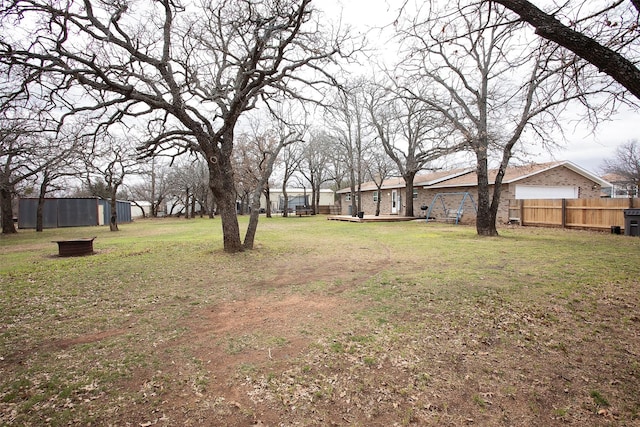 view of yard with fence and a wooden deck