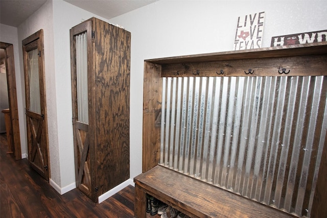 mudroom featuring baseboards and wood finished floors