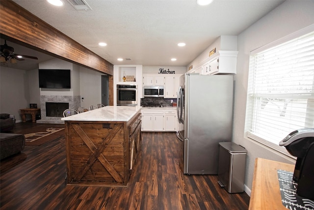 kitchen featuring a healthy amount of sunlight, white cabinetry, visible vents, and stainless steel appliances