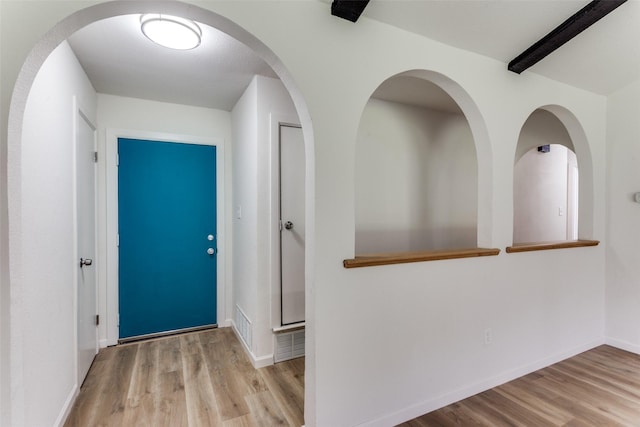 foyer entrance featuring wood finished floors, visible vents, and baseboards