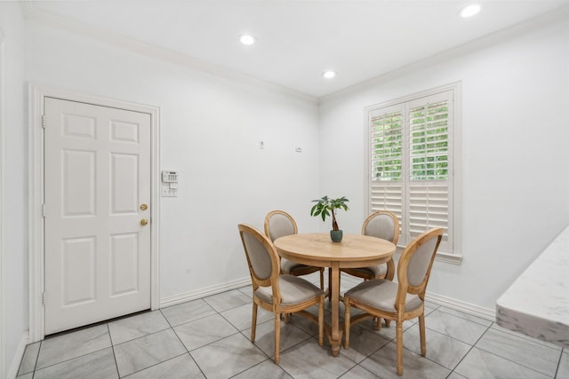 dining room with ornamental molding, baseboards, and light tile patterned floors