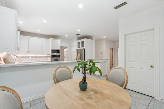 dining space featuring light tile patterned floors, ornamental molding, visible vents, and recessed lighting