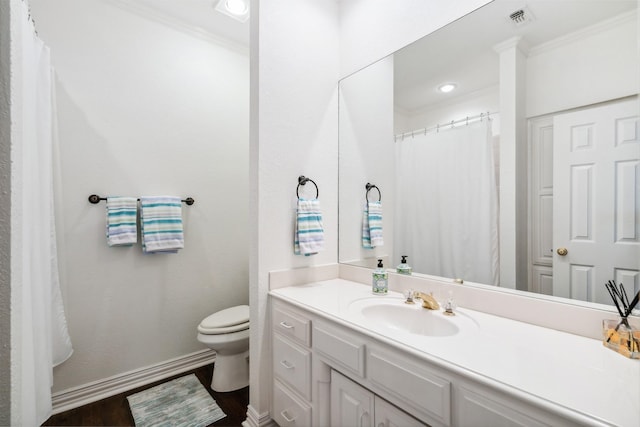 full bath with baseboards, toilet, wood finished floors, crown molding, and vanity