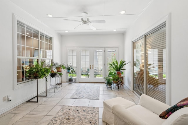 interior space with a ceiling fan and french doors