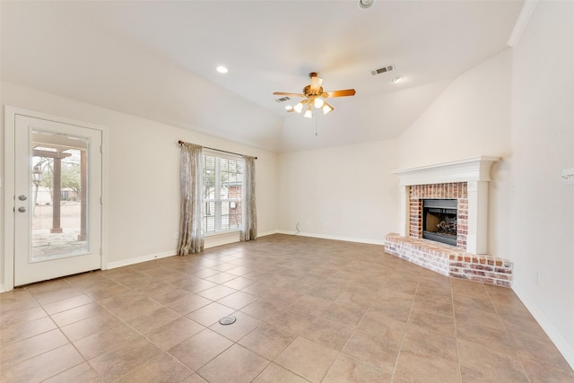 unfurnished living room with baseboards, visible vents, a ceiling fan, lofted ceiling, and a fireplace