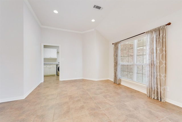 unfurnished room featuring visible vents, baseboards, vaulted ceiling, washer / clothes dryer, and crown molding