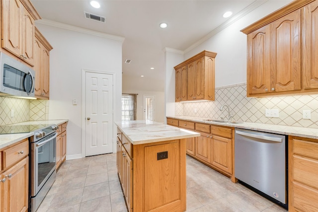 kitchen with stainless steel appliances, a sink, visible vents, and crown molding