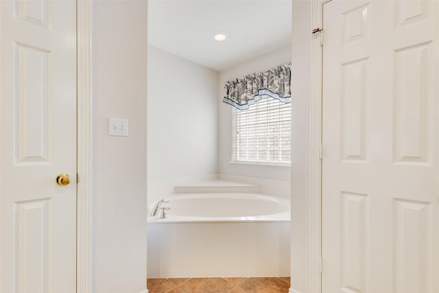 full bath featuring tile patterned flooring and a bath