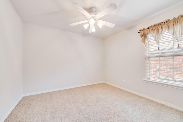 carpeted spare room with plenty of natural light, baseboards, and a ceiling fan