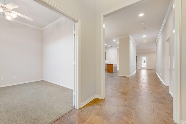 corridor with light tile patterned floors, baseboards, ornamental molding, and recessed lighting