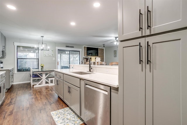 kitchen featuring a sink, dark wood-type flooring, dishwasher, and gray cabinetry