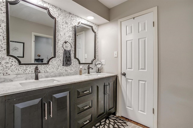 full bathroom with double vanity and a sink