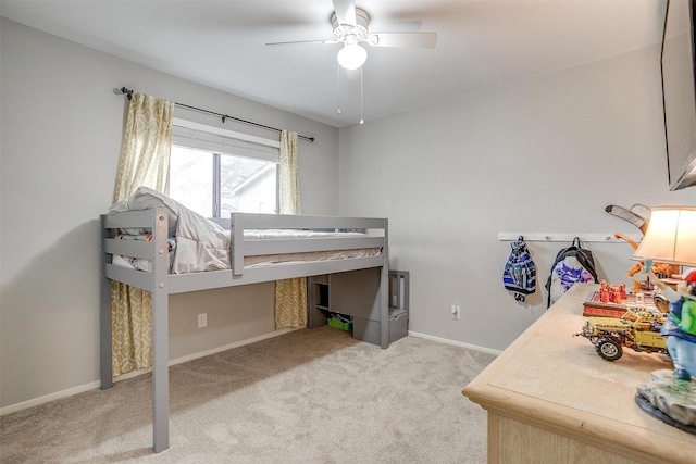 carpeted bedroom with ceiling fan and baseboards