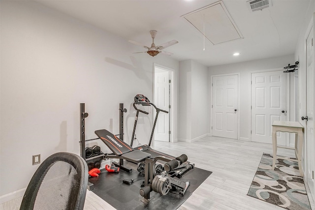 workout area with light wood-style flooring, recessed lighting, visible vents, baseboards, and attic access