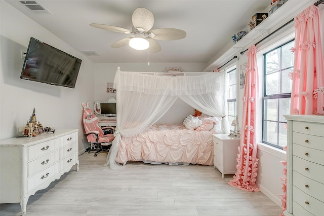 bedroom with visible vents, ceiling fan, and light wood-style flooring