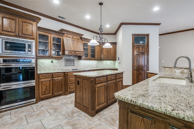 kitchen featuring stainless steel appliances, tasteful backsplash, a sink, and light stone counters