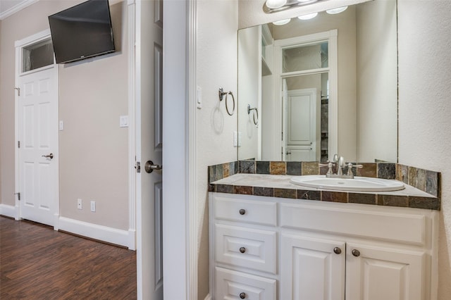 bathroom featuring vanity, baseboards, and wood finished floors