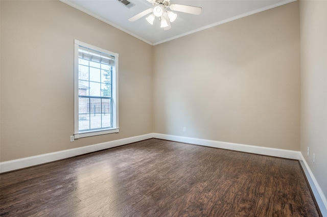 spare room with dark wood-style floors, crown molding, visible vents, ceiling fan, and baseboards