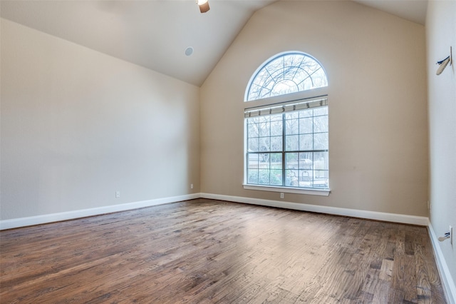 spare room with high vaulted ceiling, ceiling fan, baseboards, and wood finished floors