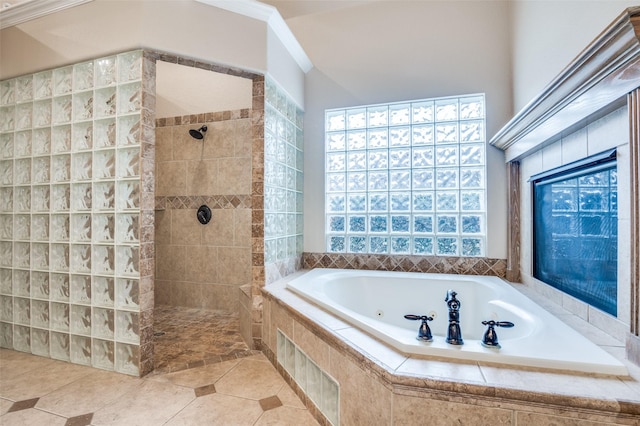 bathroom featuring a jetted tub, tile patterned flooring, a walk in shower, and crown molding