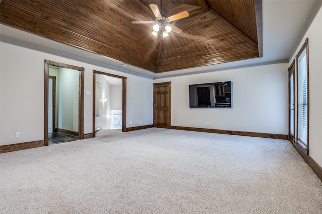 unfurnished room featuring baseboards, a raised ceiling, lofted ceiling, wooden ceiling, and carpet floors