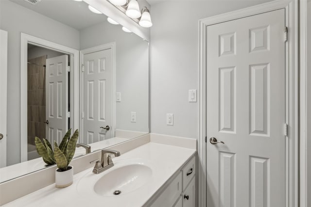 full bath with visible vents, a shower, and vanity