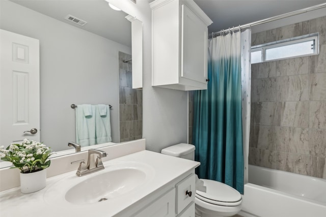 bathroom featuring shower / tub combo, visible vents, vanity, and toilet