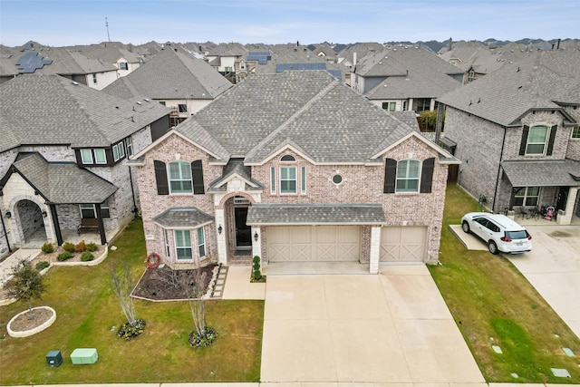 view of front facade with roof with shingles, brick siding, driveway, and an attached garage