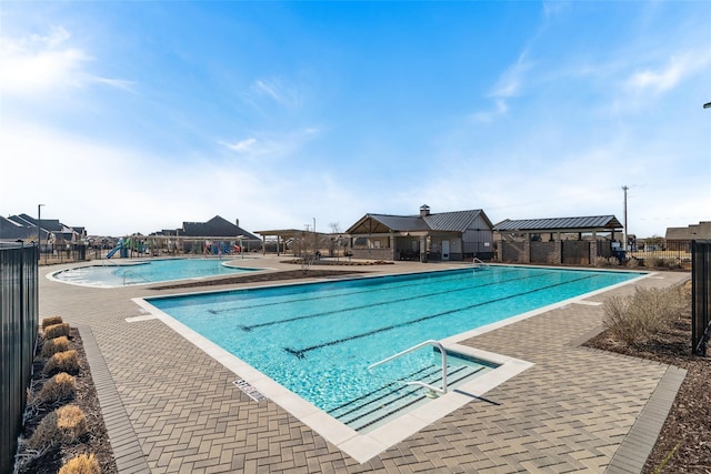 pool featuring a patio area and fence