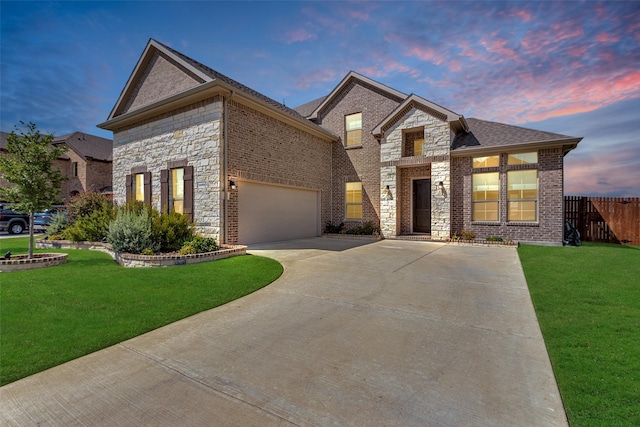 view of front facade featuring a garage, a front yard, brick siding, and fence