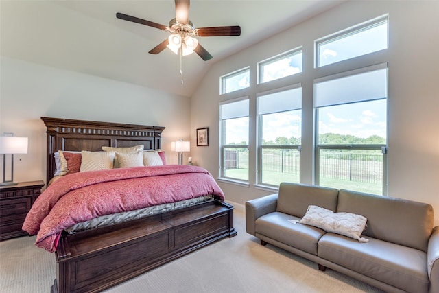 carpeted bedroom featuring lofted ceiling and a ceiling fan