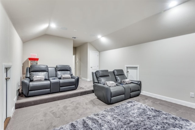 home theater room featuring carpet floors, visible vents, vaulted ceiling, and baseboards