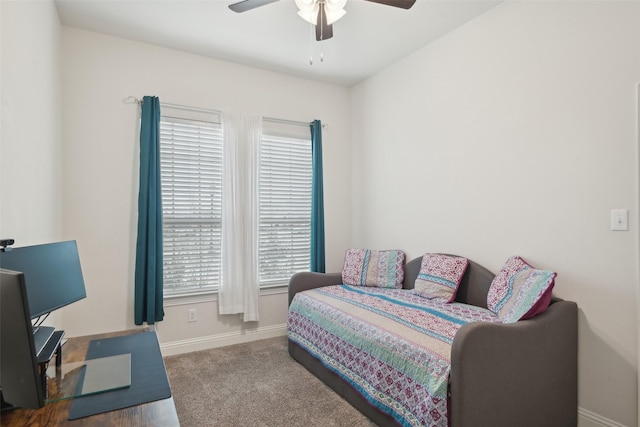 carpeted bedroom with a ceiling fan and baseboards