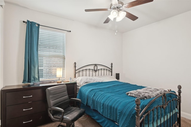 carpeted bedroom with ceiling fan and baseboards