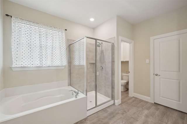 bathroom featuring toilet, a shower stall, a bath, and wood finished floors