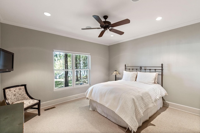 bedroom featuring carpet flooring, crown molding, visible vents, and baseboards