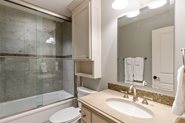 full bath featuring toilet, combined bath / shower with glass door, decorative backsplash, and vanity