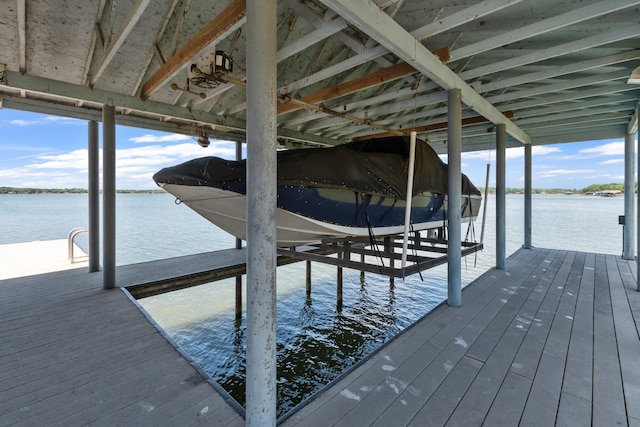 dock area with a water view and boat lift