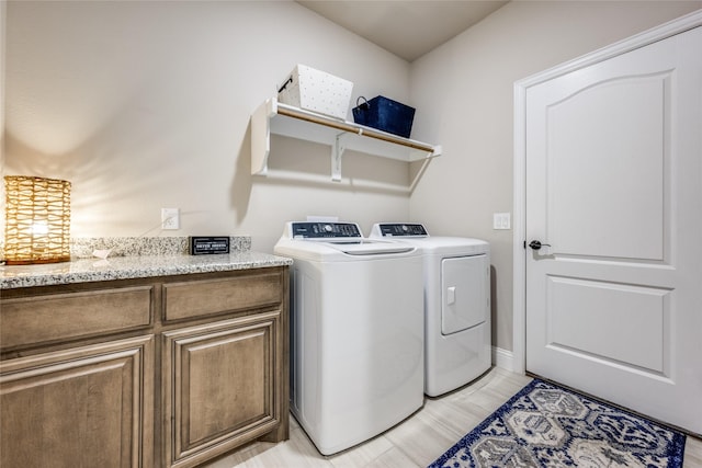 laundry room with cabinet space and independent washer and dryer