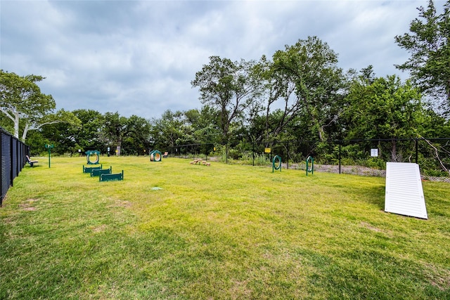 view of home's community featuring fence and a yard